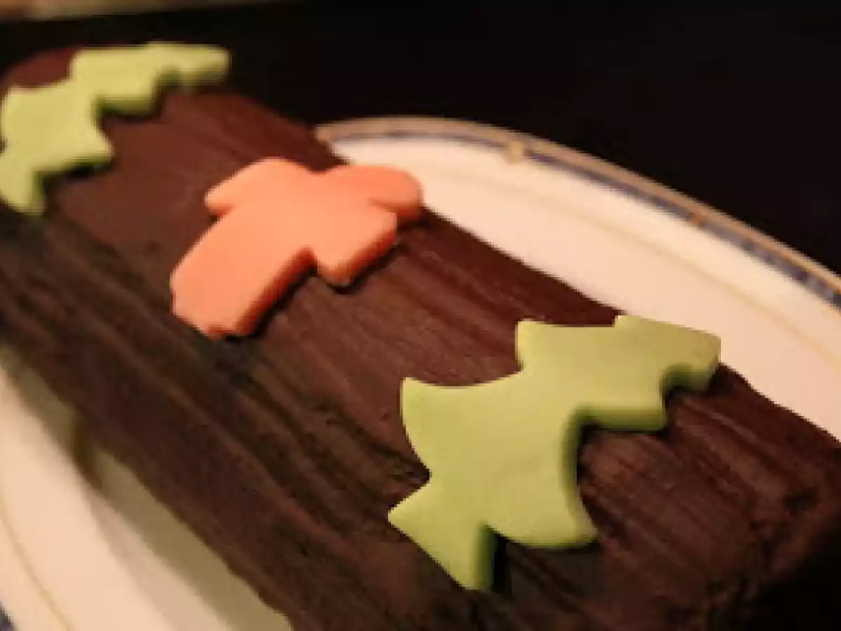 Bûche génoise crème au beurre praliné en robe de massepain, glaçage au chocolat noir